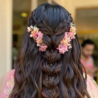 Side braid hairstyle with floral touch – hair by Udaipur artist